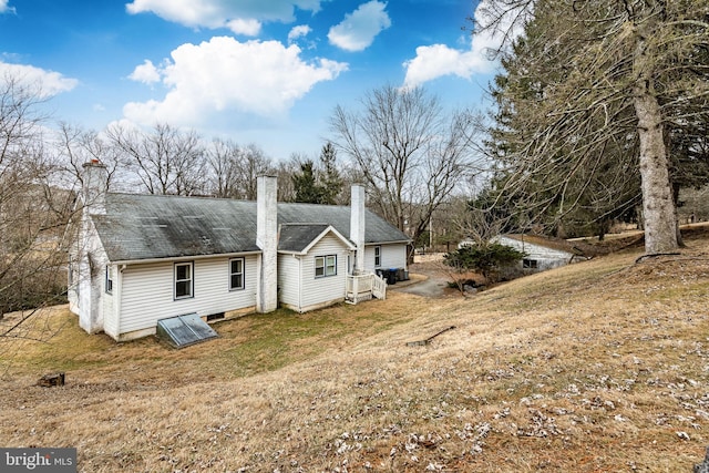 rear view of house with a yard