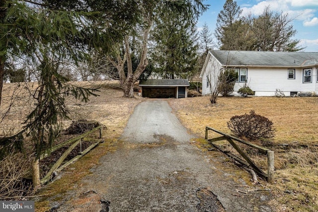 view of front of home featuring a garage and an outdoor structure