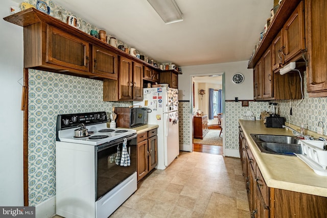 kitchen with tasteful backsplash, sink, and white appliances