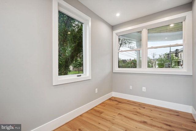 unfurnished room with light hardwood / wood-style floors