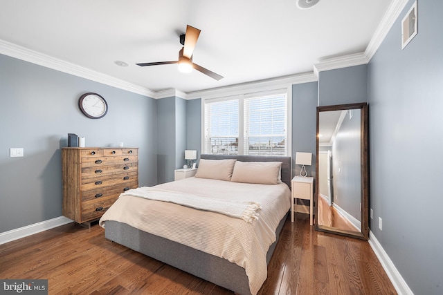 bedroom featuring dark wood-type flooring, ceiling fan, and crown molding