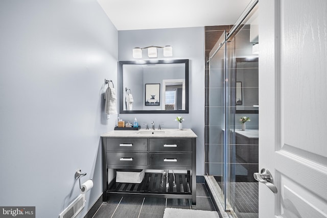 bathroom with vanity and an enclosed shower