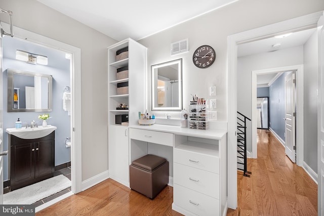 bathroom featuring hardwood / wood-style flooring and vanity