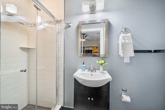 bathroom with vanity and a shower with shower door