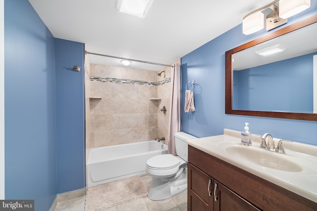 full bathroom featuring tiled shower / bath, vanity, toilet, and tile patterned floors