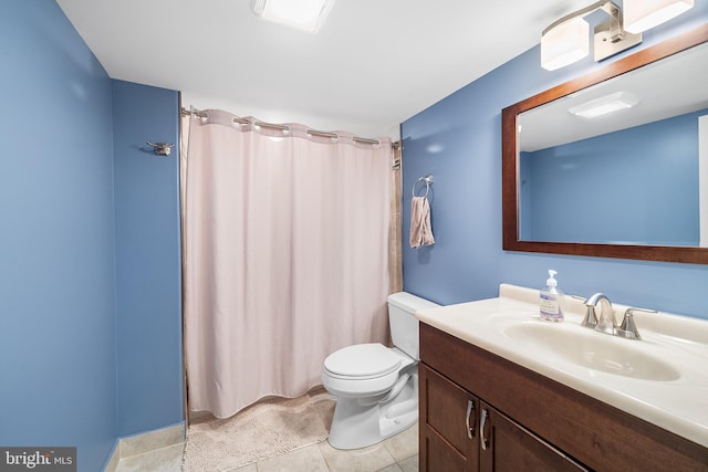 bathroom with vanity, tile patterned floors, and toilet