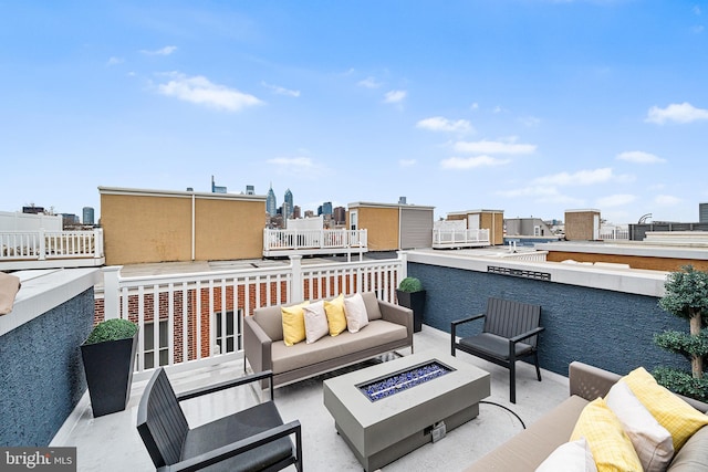 view of patio featuring an outdoor living space with a fire pit