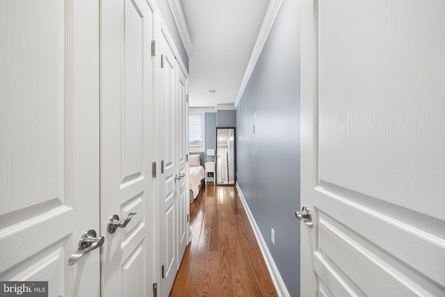 hall with dark hardwood / wood-style flooring and crown molding