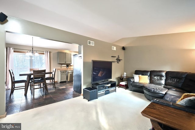 living room with an inviting chandelier and dark carpet