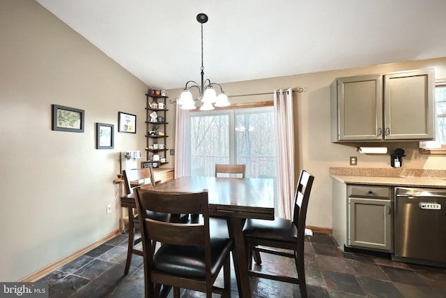 dining space with vaulted ceiling and an inviting chandelier