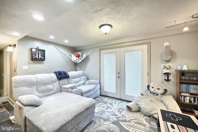 living room featuring a textured ceiling and french doors