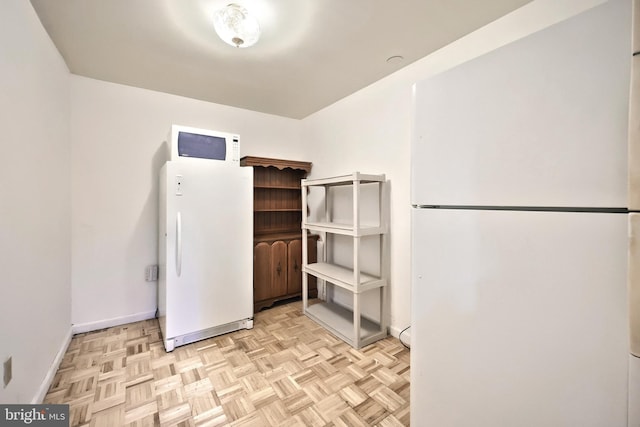 kitchen featuring white appliances and light parquet floors