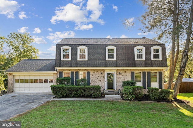 dutch colonial with a garage, aphalt driveway, roof with shingles, a front lawn, and brick siding