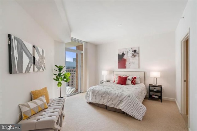 carpeted bedroom featuring baseboards, access to outside, and floor to ceiling windows