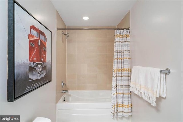 full bath featuring toilet and shower / tub combo with curtain