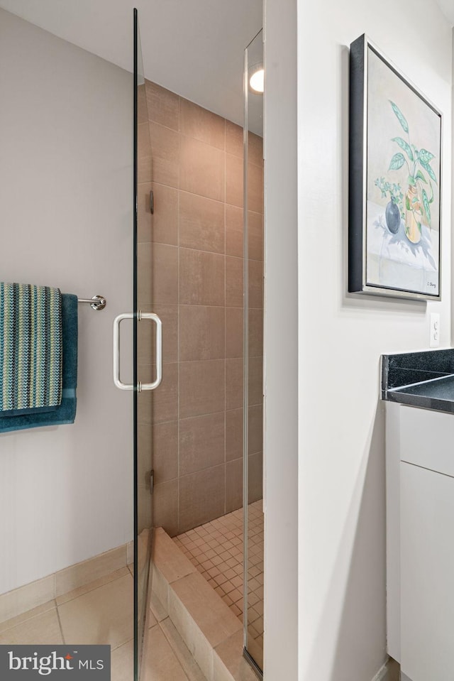 11990 Market St Unit 1311, Reston, VA 20190 - full bathroom featuring vanity, baseboards, tile patterned flooring, and a shower stall