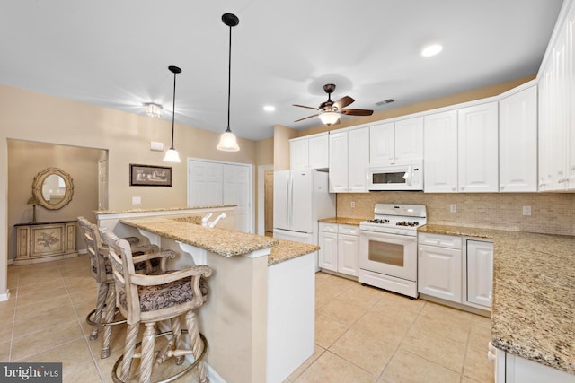 kitchen featuring white cabinetry, white appliances, a center island, and pendant lighting