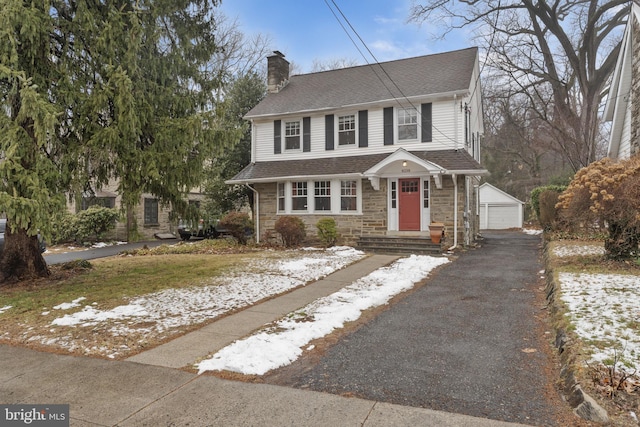 view of front of home featuring a garage and an outdoor structure