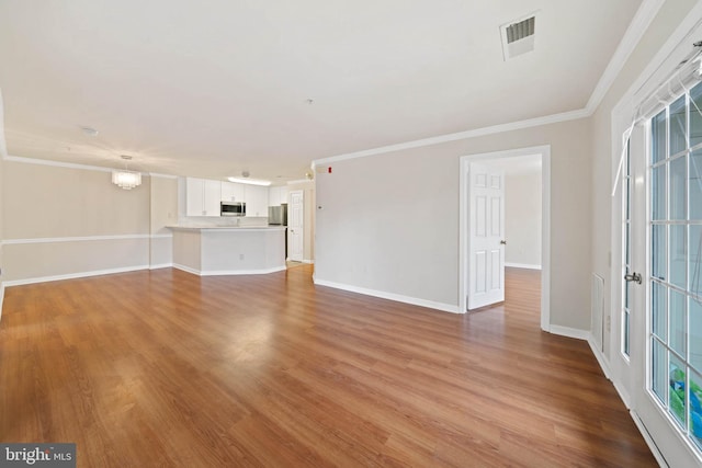 unfurnished living room with ornamental molding and light hardwood / wood-style flooring