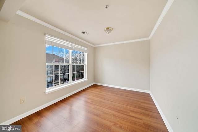 unfurnished room featuring crown molding and wood-type flooring