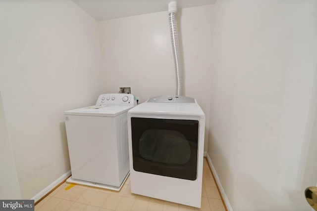 washroom featuring independent washer and dryer and light tile patterned floors