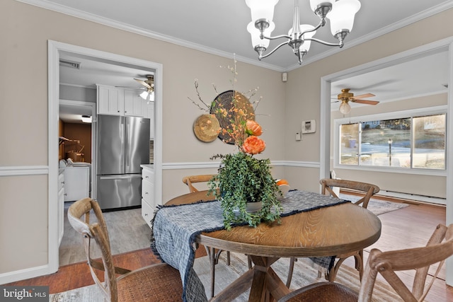 dining space with ornamental molding, light hardwood / wood-style floors, and ceiling fan with notable chandelier