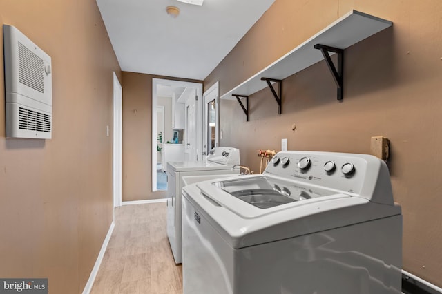 clothes washing area featuring washing machine and dryer and heating unit