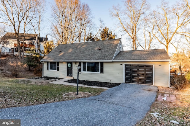 view of front facade with a front yard and a garage