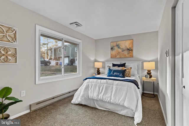 carpeted bedroom with baseboard heating