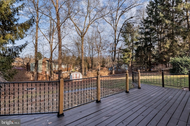 wooden deck featuring a storage unit