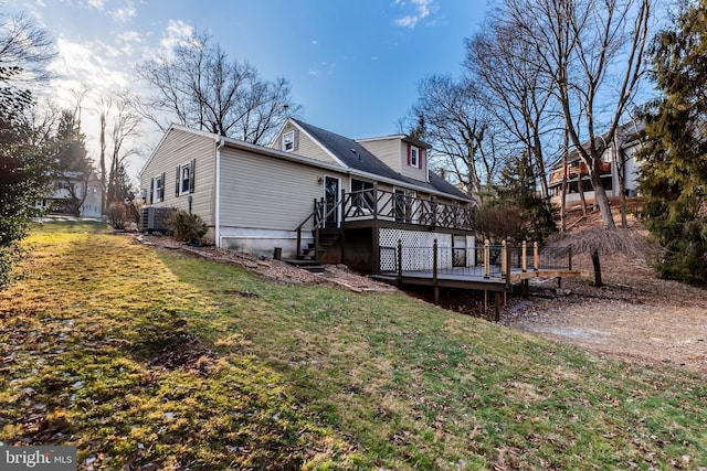 rear view of house featuring a yard and a wooden deck