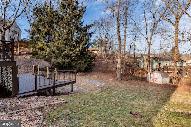 view of yard featuring a shed and a wooden deck