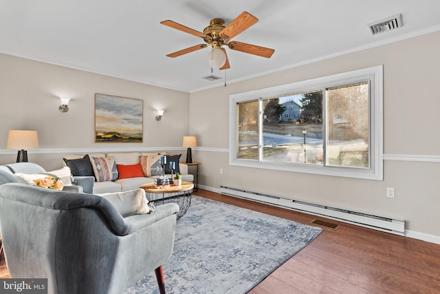 living room with hardwood / wood-style floors, baseboard heating, ceiling fan, and ornamental molding