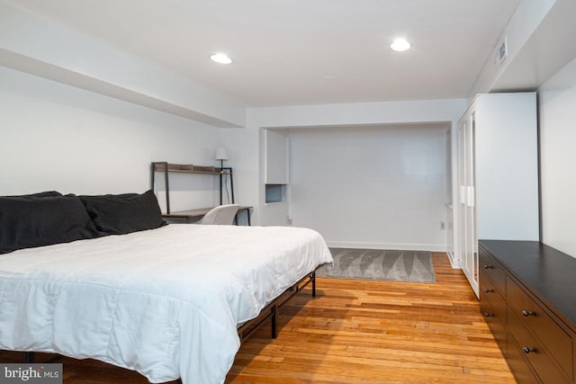 bedroom featuring baseboards, recessed lighting, and light wood-style floors