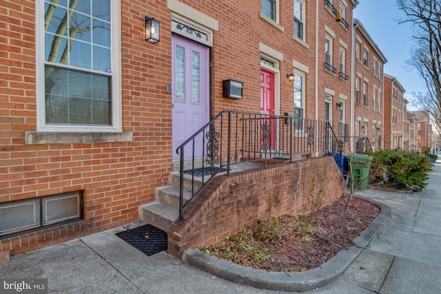 property entrance featuring brick siding