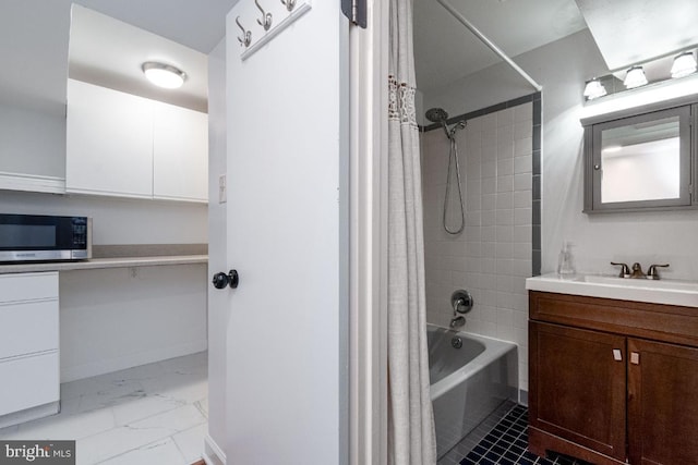 full bathroom featuring marble finish floor, vanity, and shower / tub combo with curtain