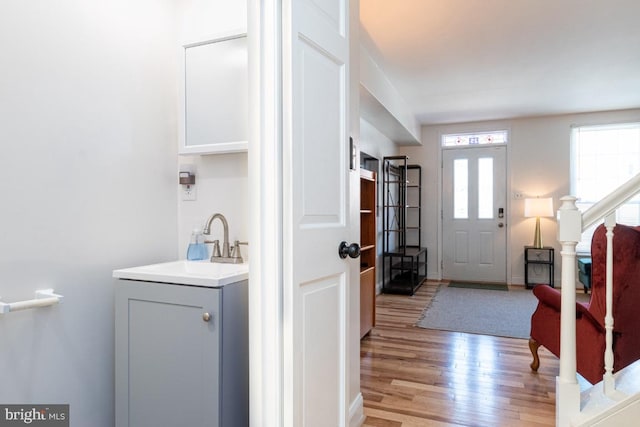 foyer featuring light wood-style floors and stairs