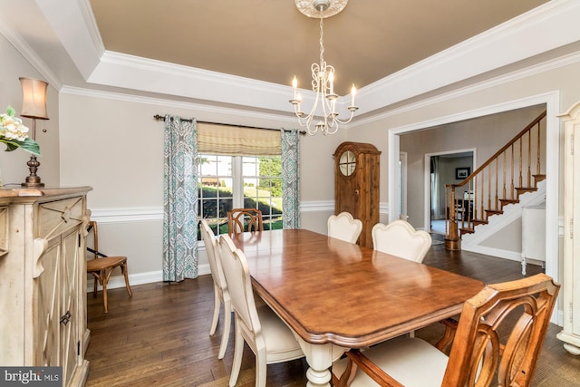 dining area featuring an inviting chandelier, dark hardwood / wood-style flooring, a raised ceiling, and crown molding