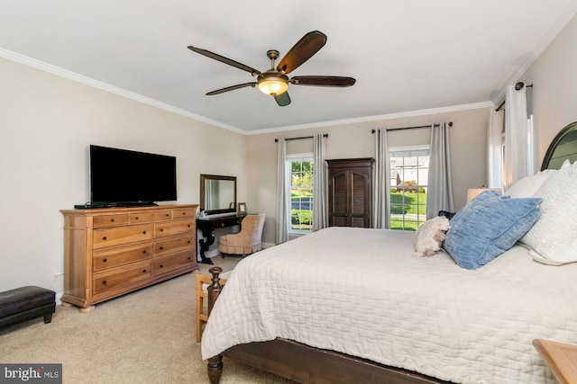 carpeted bedroom with ornamental molding and ceiling fan