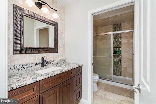 bathroom with vanity, toilet, and walk in shower