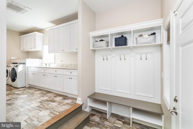 mudroom with sink and washing machine and clothes dryer