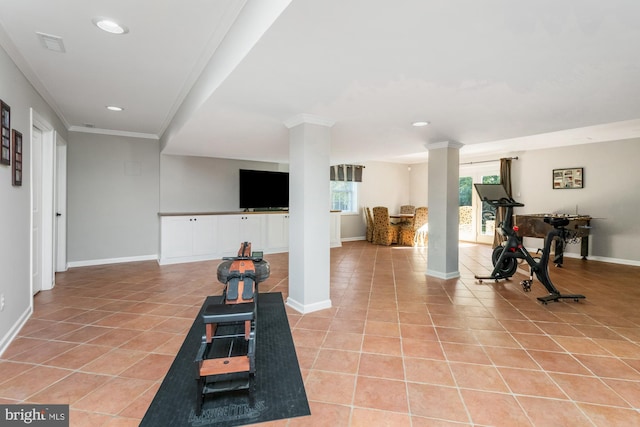 workout room with light tile patterned flooring, crown molding, and decorative columns