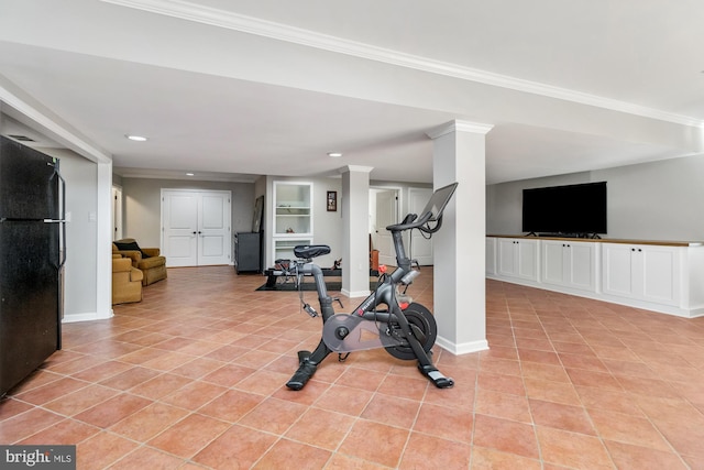 workout room with crown molding and light tile patterned floors