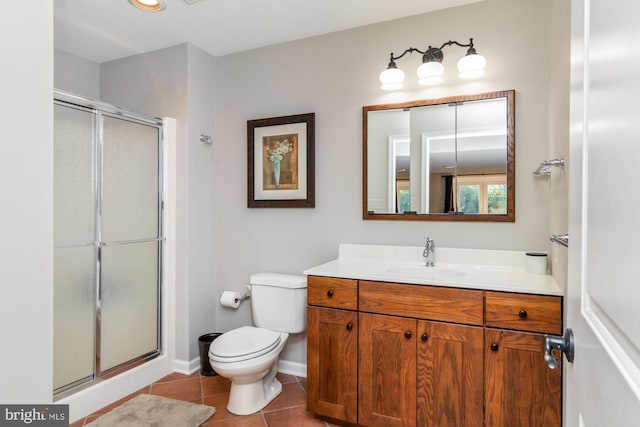 bathroom featuring vanity, toilet, an enclosed shower, and tile patterned flooring