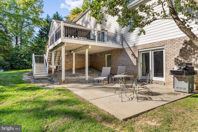 rear view of house featuring a wooden deck, a yard, a sunroom, and a patio