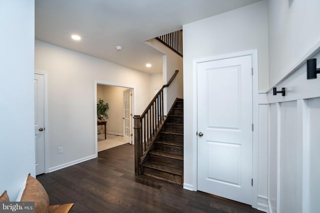 staircase with hardwood / wood-style floors