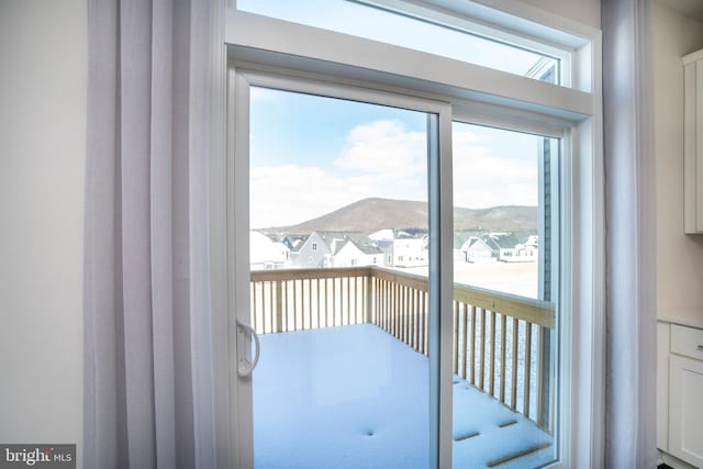 doorway to outside featuring a mountain view