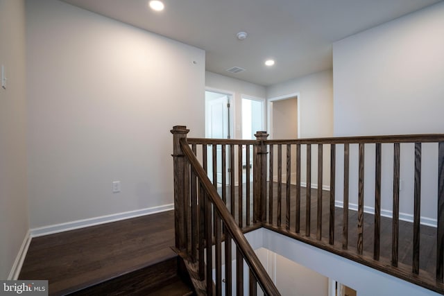 staircase with hardwood / wood-style flooring