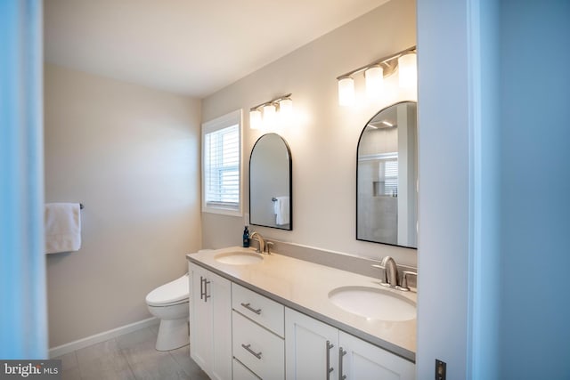 bathroom featuring vanity, toilet, and tile patterned flooring