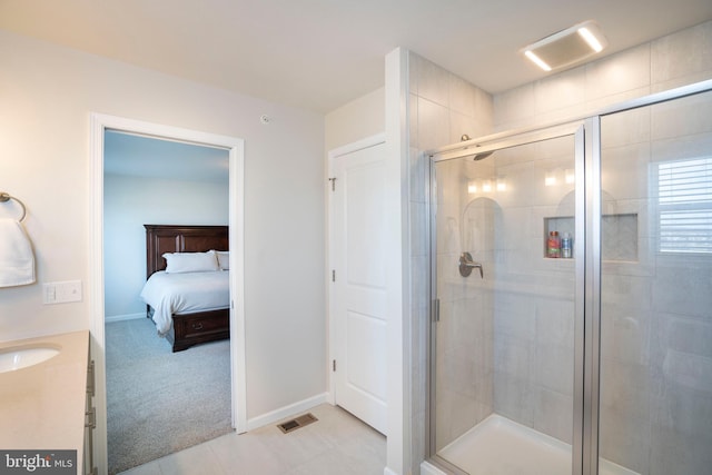 bathroom featuring vanity and an enclosed shower